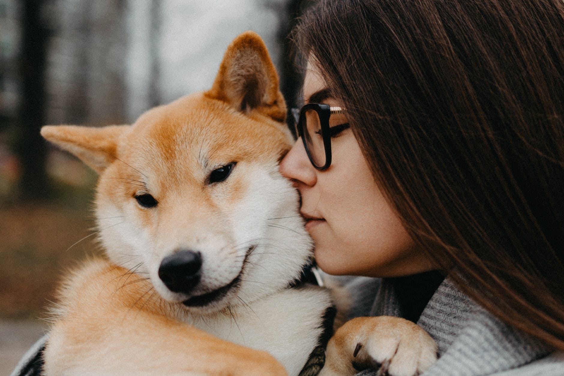 beautiful woman kissing her dog